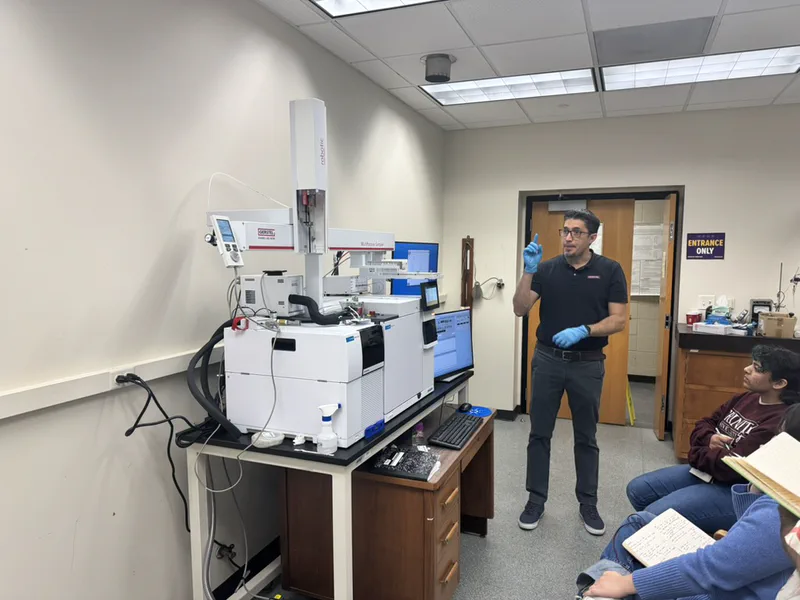 A demonstration beside the newly installed Agilent GC–MS and GERSTEL autosampler, with lab members taking notes.