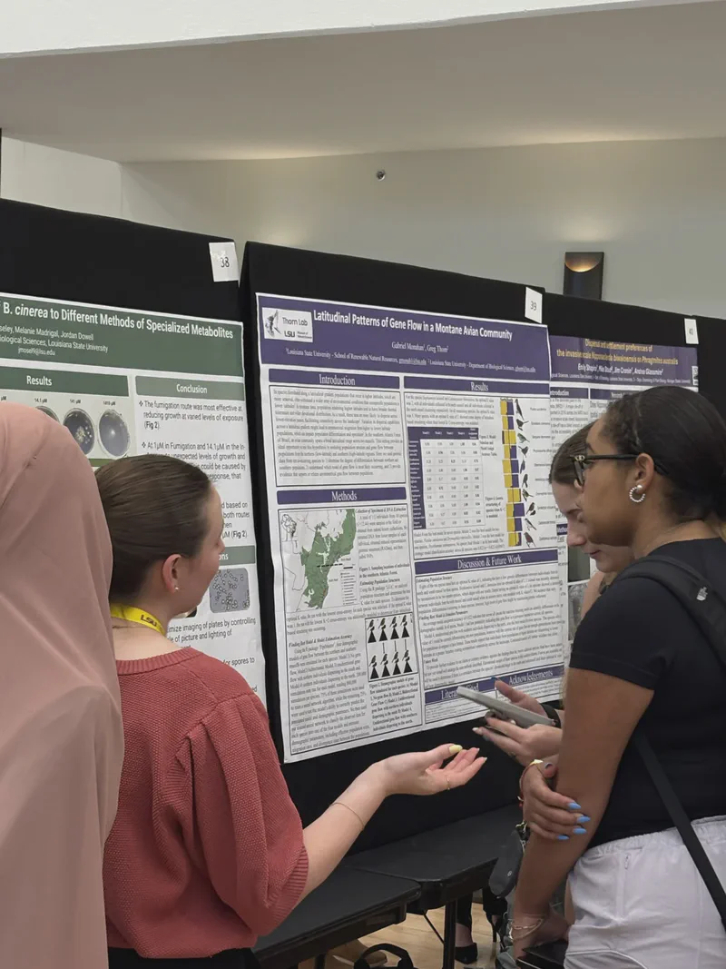 Researchers discussing a scientific poster in an exhibition hall.